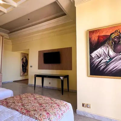 a bedroom with a desk and a painting on the wall at Royal Mirage Deluxe in Marrakech