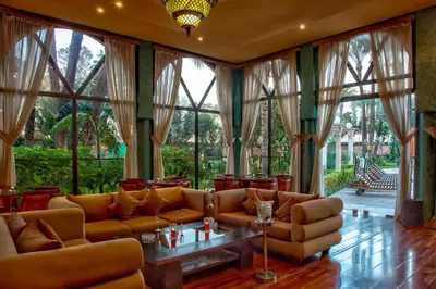 a living room with couches and tables and large windows at Royal Mirage Deluxe in Marrakech