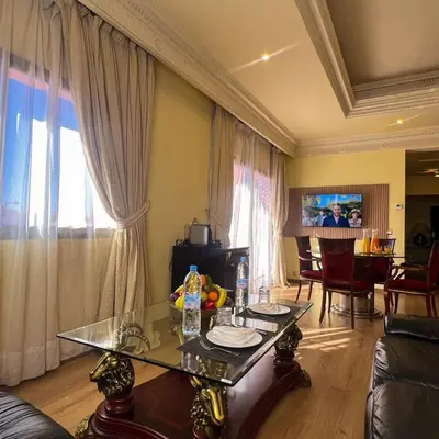 a living room with a table and a couch at Royal Mirage Deluxe in Marrakech