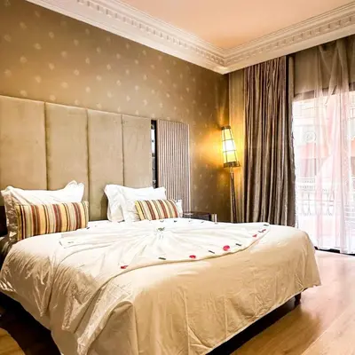 a bedroom with a large white bed with a large window at Royal Mirage Deluxe in Marrakech