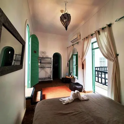 a bedroom with a bed with a towel on it at Riad El Grably in Marrakech