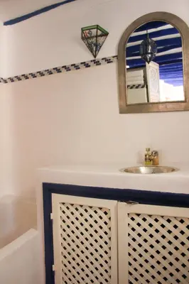 a bathroom with a sink and a mirror at Riad Dar Nael in Marrakech
