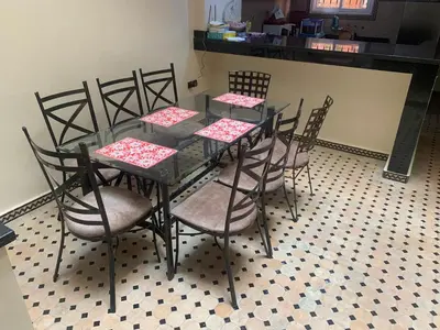 a glass table and chairs with red and white napkins at Riad jmiaa in Marrakech