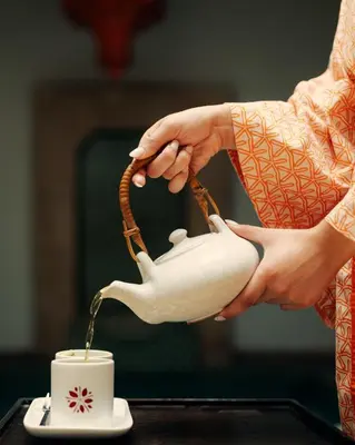 a person is pouring coffee into a cup at Marrakech Riads, Angsana Heritage Collection in Marrakech