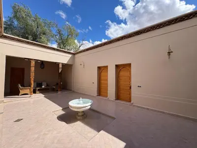 a courtyard with a fountain in the middle of a building at Les Deux Tours in Marrakech