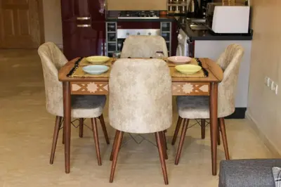 a dining room table and chairs with bowls on it at Bright Apt in the Heart of Marrakech-Walk Everywhere in Marrakech