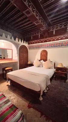 a bedroom with a large bed in a room at Riad Catalina in Marrakech