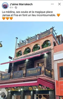 a building with a sign on the side of it at Hotel Agnaoue in Marrakech