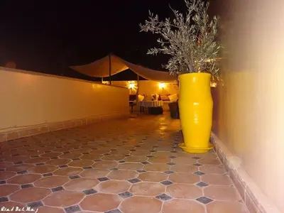 a large yellow vase sitting on the side of a wall at Riad Bel Haj in Marrakech