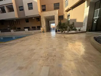 an empty hallway of a building with a courtyard at Appart Kech Menera in Marrakech