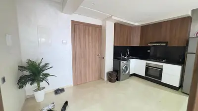 a room with a kitchen with a door and a plant at Appart Kech Menera in Marrakech