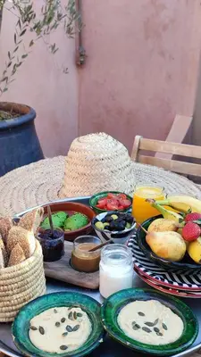 a table with plates of food on top of it at Riad Dar Zaman in Marrakech