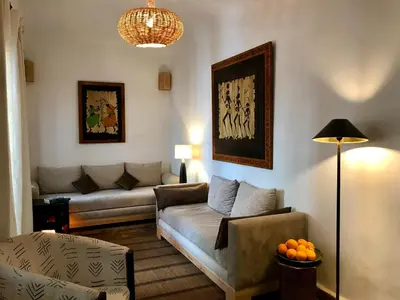 a living room with a couch and a table at Riad Dar Zaman in Marrakech