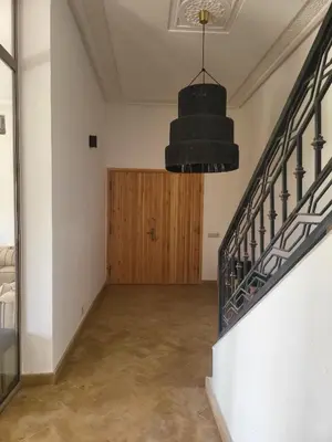 an empty room with a staircase and a wooden door at Dar Sofia Villa in Marrakech