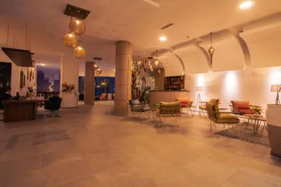 a lobby with chairs and tables in a building at Dellarosa Boutique Hotel and Spa in Marrakech