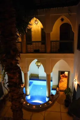 a swimming pool in the middle of a building at Riad Al Faras in Marrakech