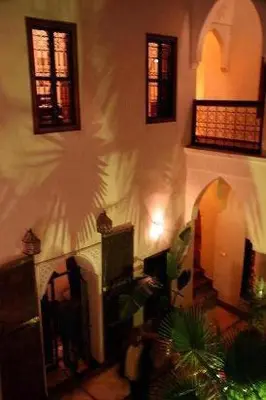 a room with a wall with windows and a building at Riad Al Faras in Marrakech