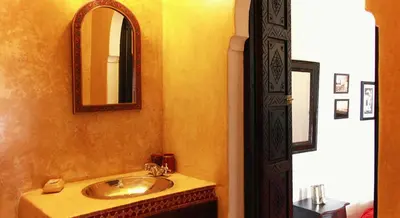 a bathroom with a sink and a mirror at Riad Al Karama in Marrakech