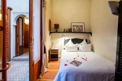 a bedroom with a bed with flowers on it at Riad Dar Justo Hotel Boutique & Spa in Marrakech