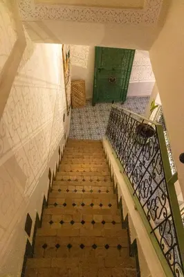 an overhead view of a staircase with a green door at Riad Med Agorà in Marrakech