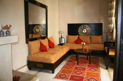 a living room with a couch and a table at Riad Diana in Marrakech