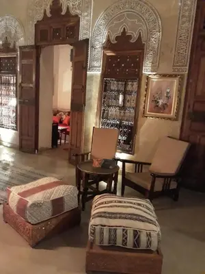 a room with chairs and a table and someitures at Riad Dar Zaya in Marrakech