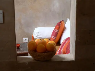 a basket of oranges in a room with a bed at Riad Dar Zaya in Marrakech