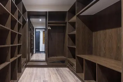 a walk in closet with dark wood cabinets at Eden Andalou Aquapark & Spa in Marrakech