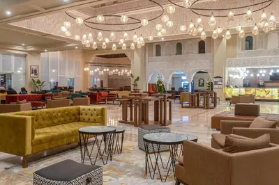 a lobby with a couch and tables and chairs at Eden Andalou Aquapark & Spa in Marrakech