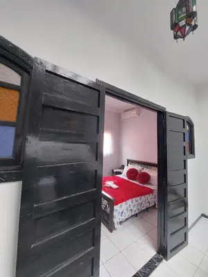 a door leading into a bedroom with a bed at Riad Al Nakhil in Marrakech