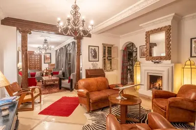 a living room with a chandelier and a fireplace at Riad Alma in Marrakech