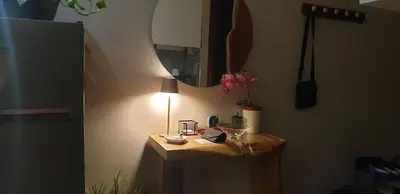 a small table in a room with a lamp on it at Bel appartement moderne au cœur de guelize in Marrakech
