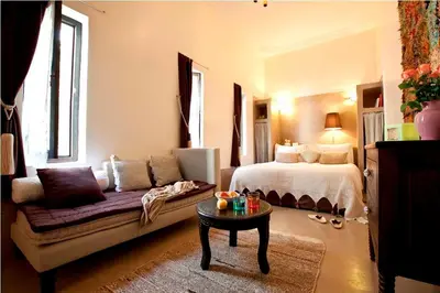 a bedroom with a bed and a couch and a table at Riad Davia in Marrakech