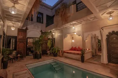 a house with a swimming pool in the middle of it at Riad Spa Sindibad in Marrakech