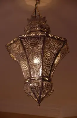 a large chandelier hanging from a ceiling at Riad Aderbaz in Marrakech