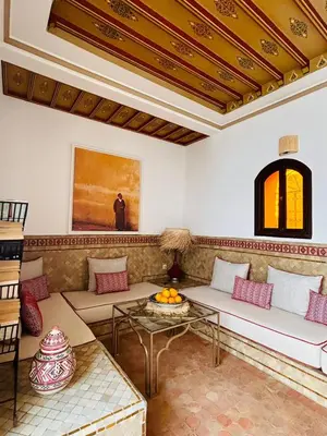 a living room with a couch and a table at Riad Bamaga in Marrakech