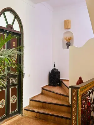 a room with stairs and a door with a plant at Riad Bamaga in Marrakech