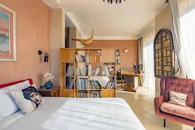 a bedroom with a bed and a book shelf at La villa Kela Serene 4 suites in Marrakech