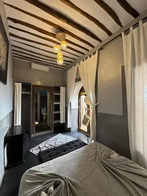 a bedroom with a bed and a ceiling at Riad Des Arts in Marrakech