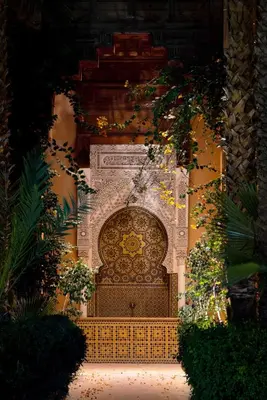 a stone wall with a gate in the middle at Les Jardins De La Koutoubia in Marrakech