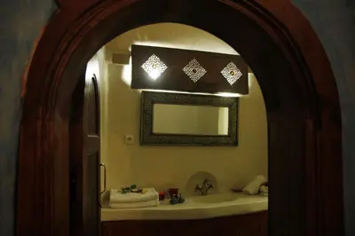 a bathroom with a mirror and a sink at Riad Azenzer in Marrakech