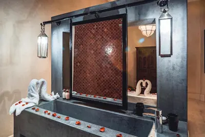 a bathroom with a large mirror and a sink at Ambre Epices Medina Riad in Marrakech