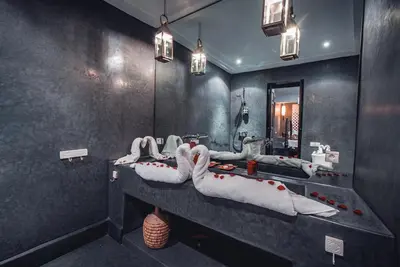 a bathroom with three sinks and a large mirror at Ambre Epices Medina Riad in Marrakech