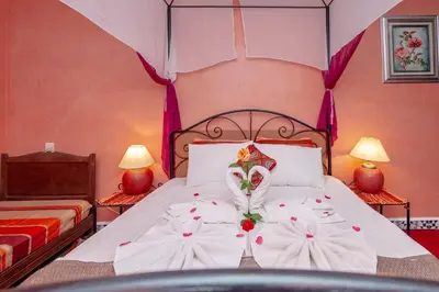 a bedroom with a bed with flowers on it at Riad Losra in Marrakech