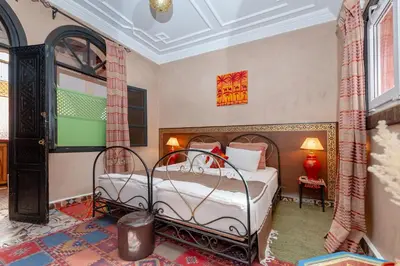 a bedroom with two beds in a room at Riad Losra in Marrakech