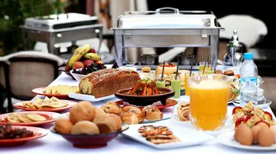 a table topped with plates of food and drinks at Amani Hotel Suites & Spa in Marrakech