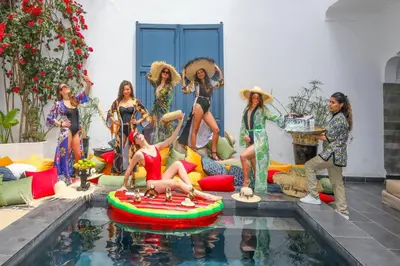 a group of women standing next to a swimming pool at Riad Anyssates in Marrakech