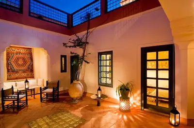 a large living room with a vaulted ceiling and a large vase at Riyad El Cadi in Marrakech