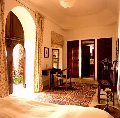 a bedroom with a bed and a desk in it at Riyad El Cadi in Marrakech