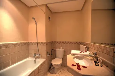 a bathroom with a sink and a toilet and a tub at Mont Gueliz in Marrakech